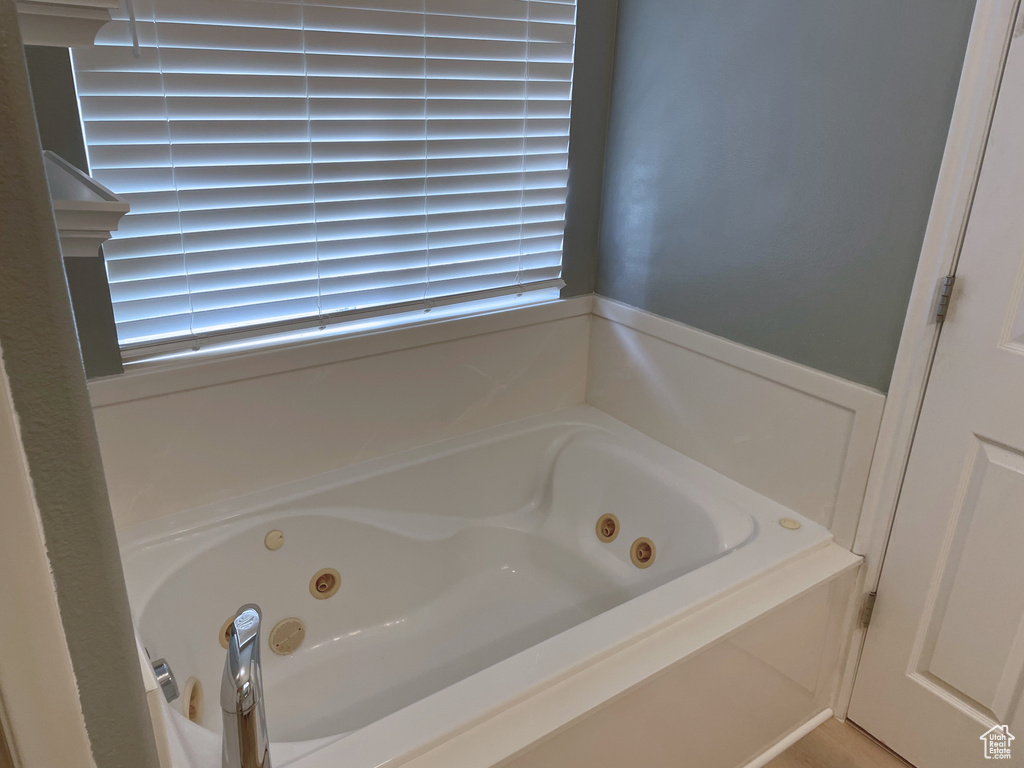 Bathroom featuring a jetted tub and wainscoting