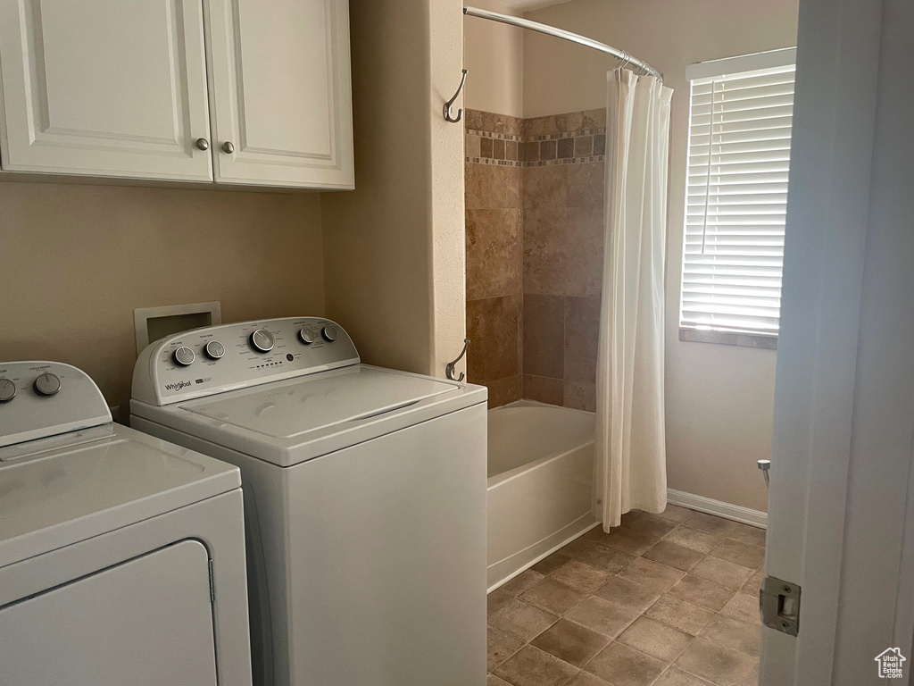 Clothes washing area with independent washer and dryer and baseboards