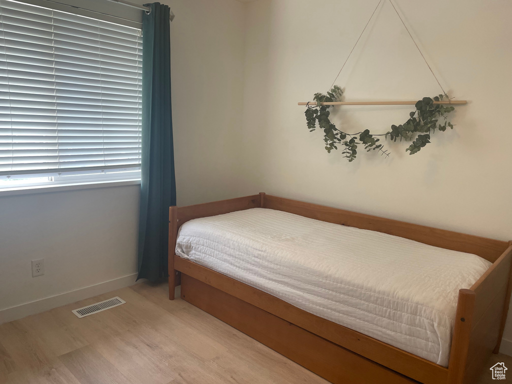 Bedroom featuring wood finished floors and baseboards
