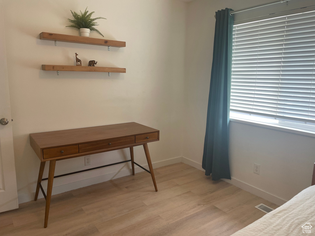 Bedroom featuring light wood-type flooring and baseboards