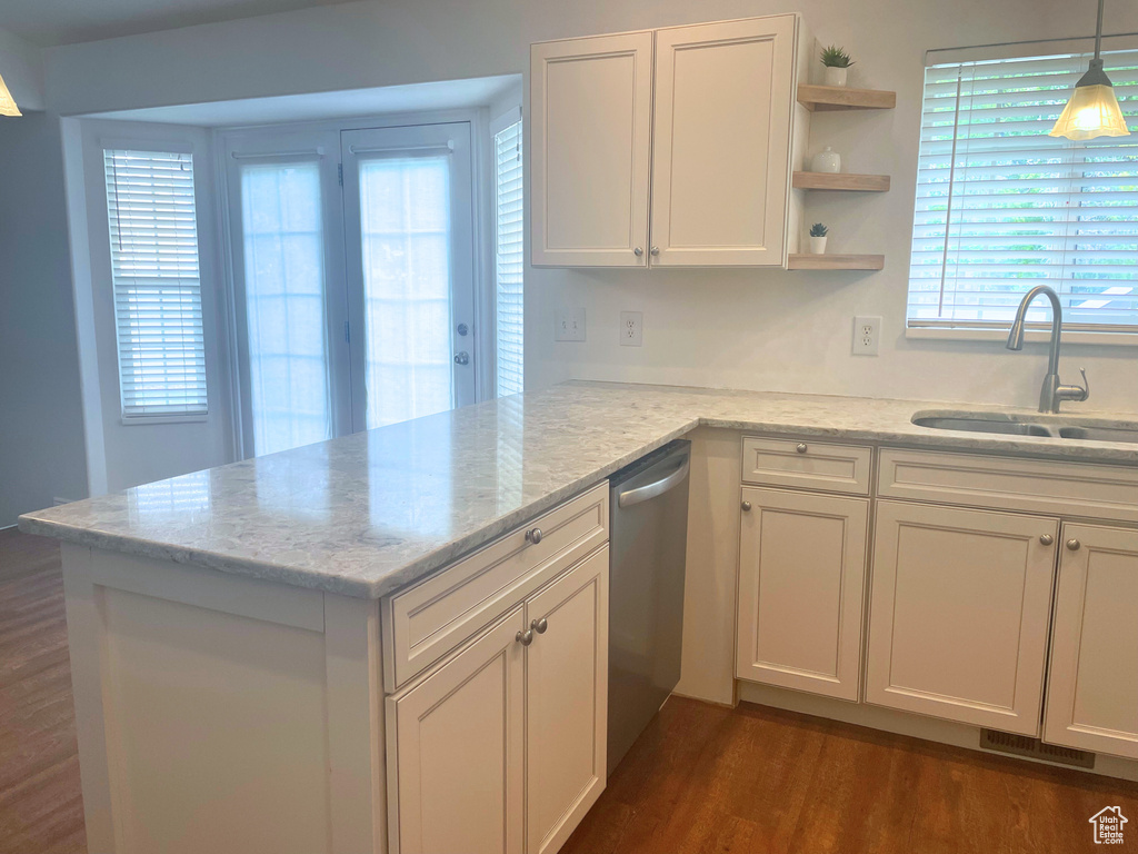Kitchen featuring a sink, white cabinetry, dishwasher, open shelves, and light stone countertops