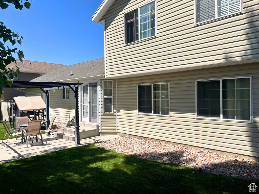Back of house featuring a patio area and a yard