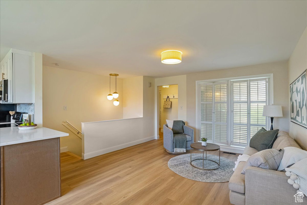 Living area with light wood finished floors and baseboards