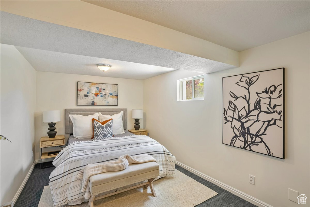Bedroom featuring carpet floors and baseboards