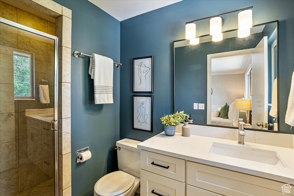 Full bath with connected bathroom, a shower stall, toilet, and vanity
