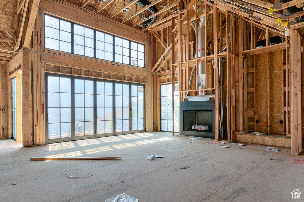 Unfurnished living room featuring a high ceiling
