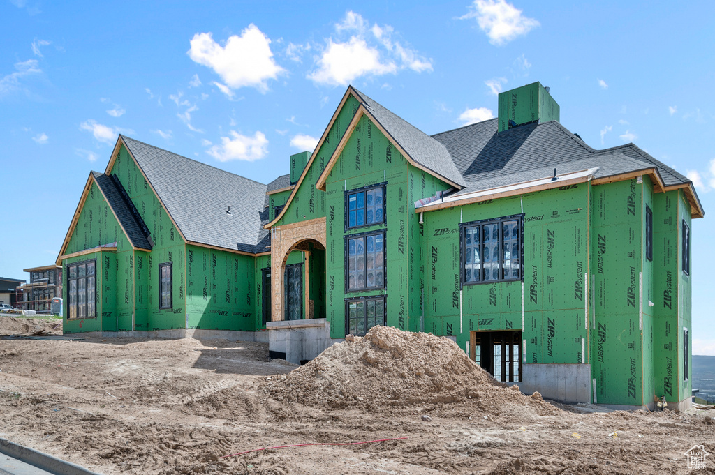 Unfinished property with roof with shingles