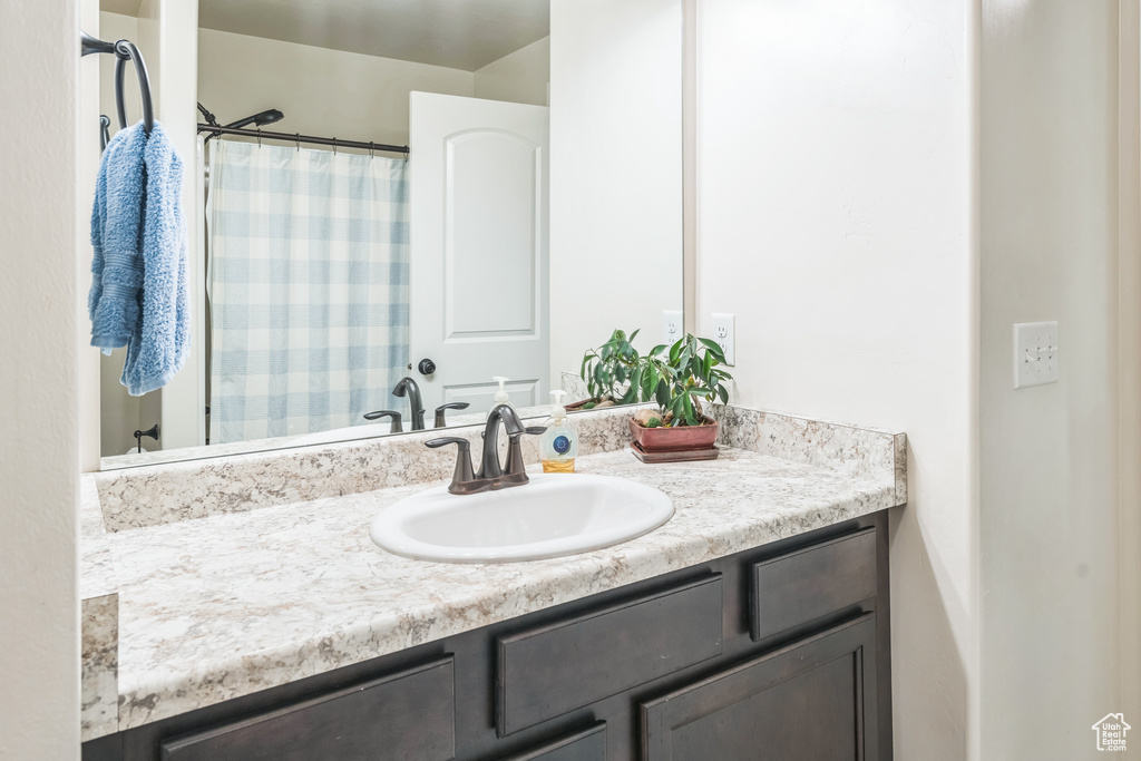 Bathroom featuring vanity and a shower with shower curtain