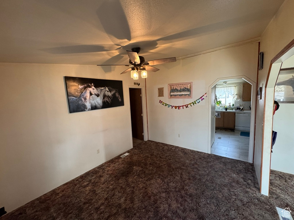Carpeted empty room with a ceiling fan
