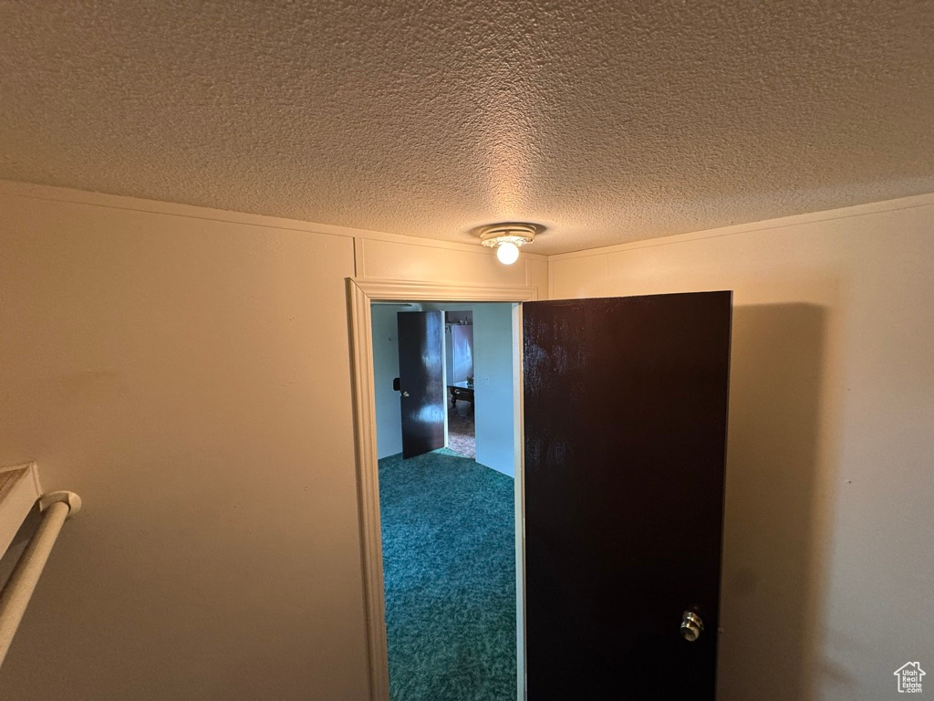 Hallway with a textured ceiling