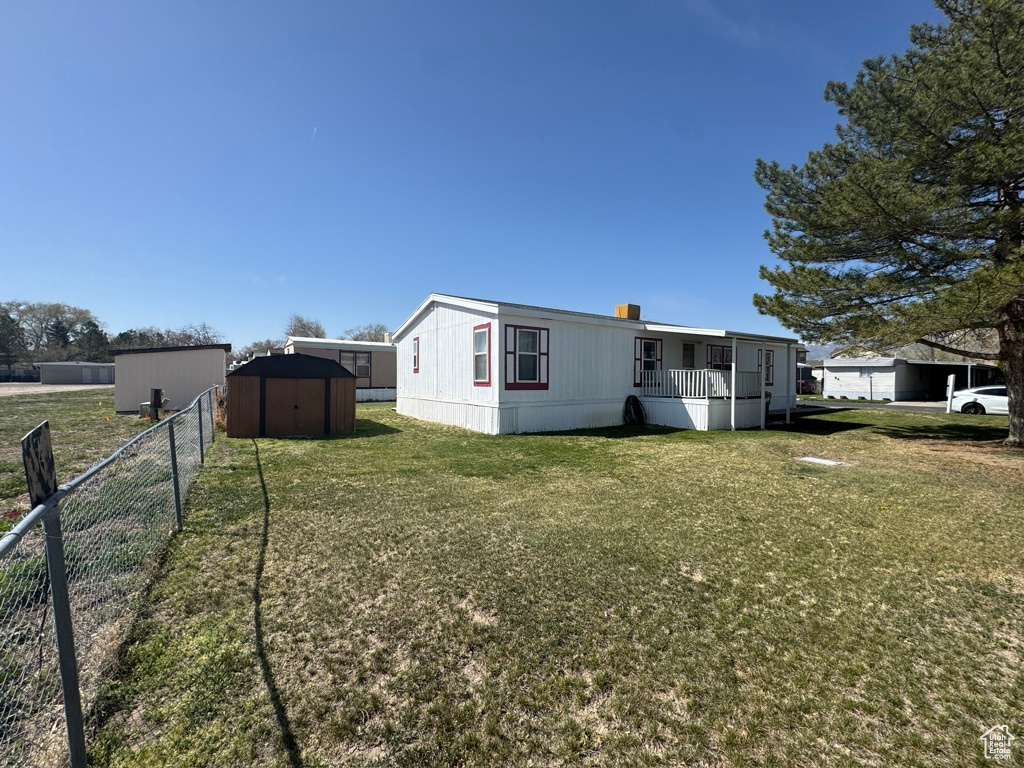 Rear view of house with a shed and an outbuilding