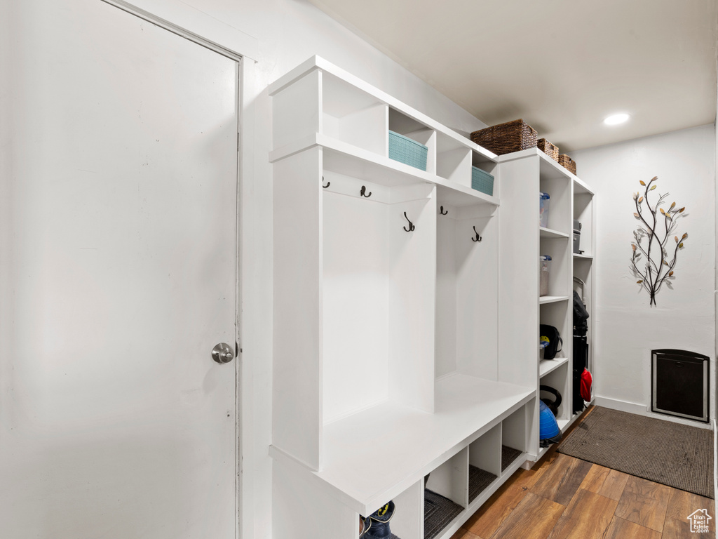 Mudroom with wood finished floors and baseboards