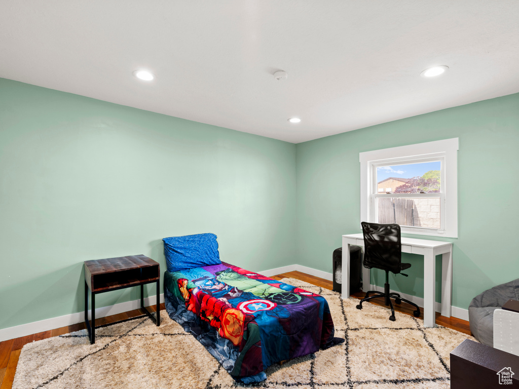 Bedroom featuring baseboards, wood finished floors, and recessed lighting