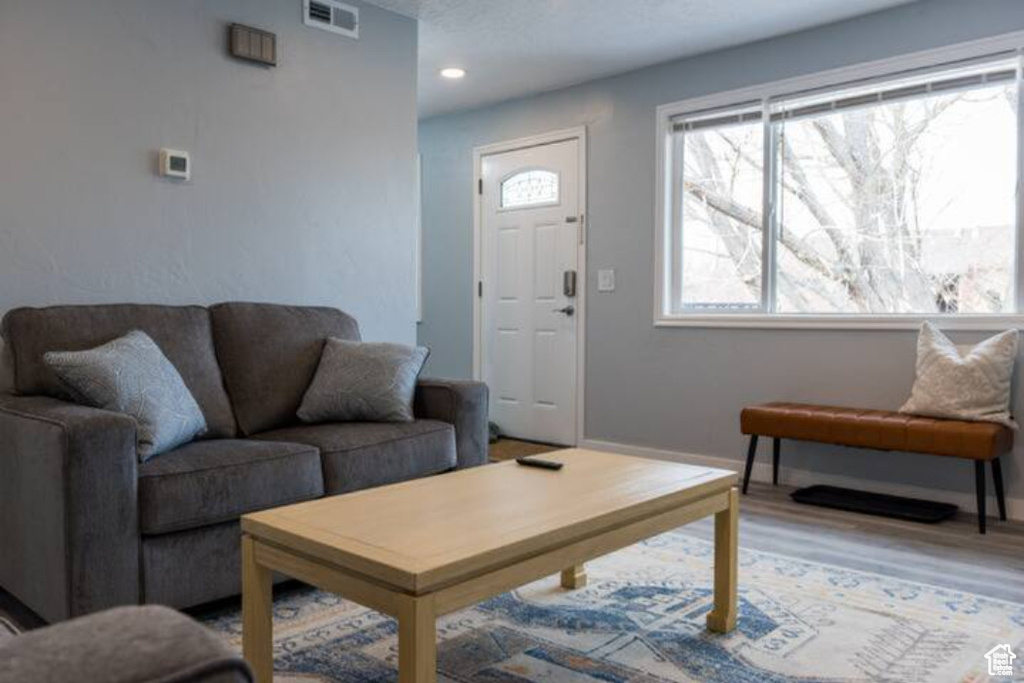 Living area with wood finished floors and baseboards