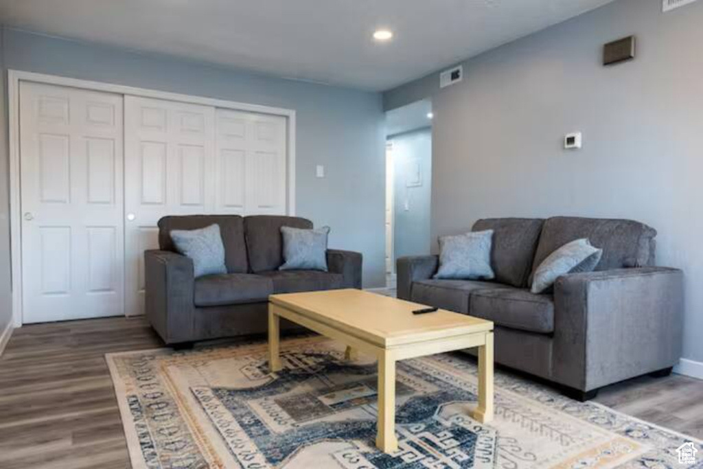 Living area featuring wood finished floors, baseboards, and recessed lighting