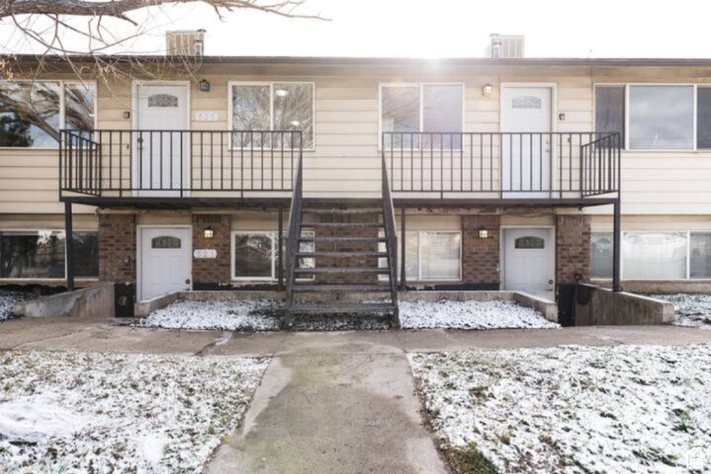 Multi unit property with stairs and brick siding