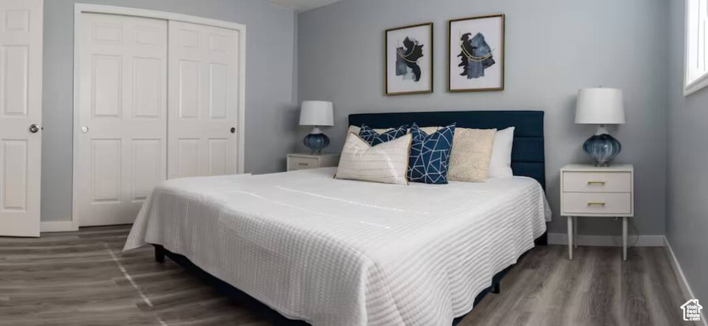 Bedroom featuring a closet, wood finished floors, and baseboards