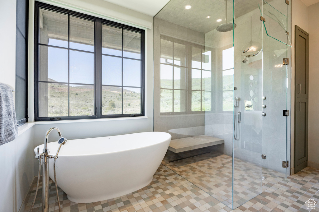 Bathroom with a soaking tub, a stall shower, recessed lighting, and tile patterned flooring
