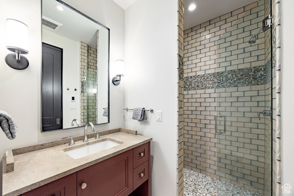 Full bath with a shower stall, recessed lighting, and vanity