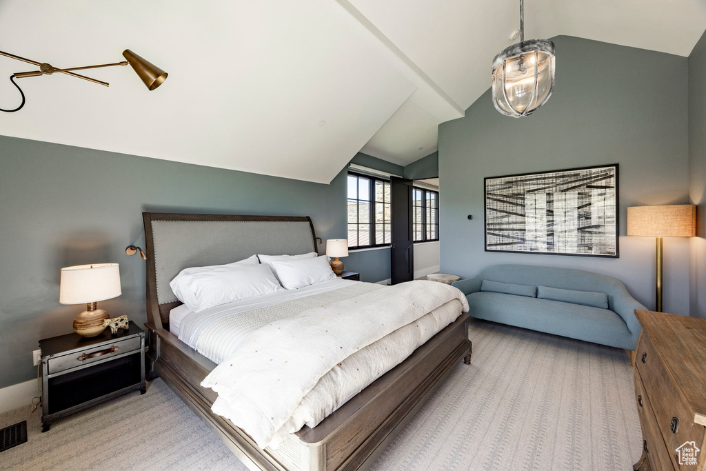 Carpeted bedroom featuring lofted ceiling