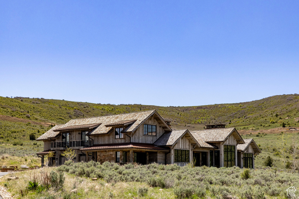 Back of property with a mountain view and board and batten siding