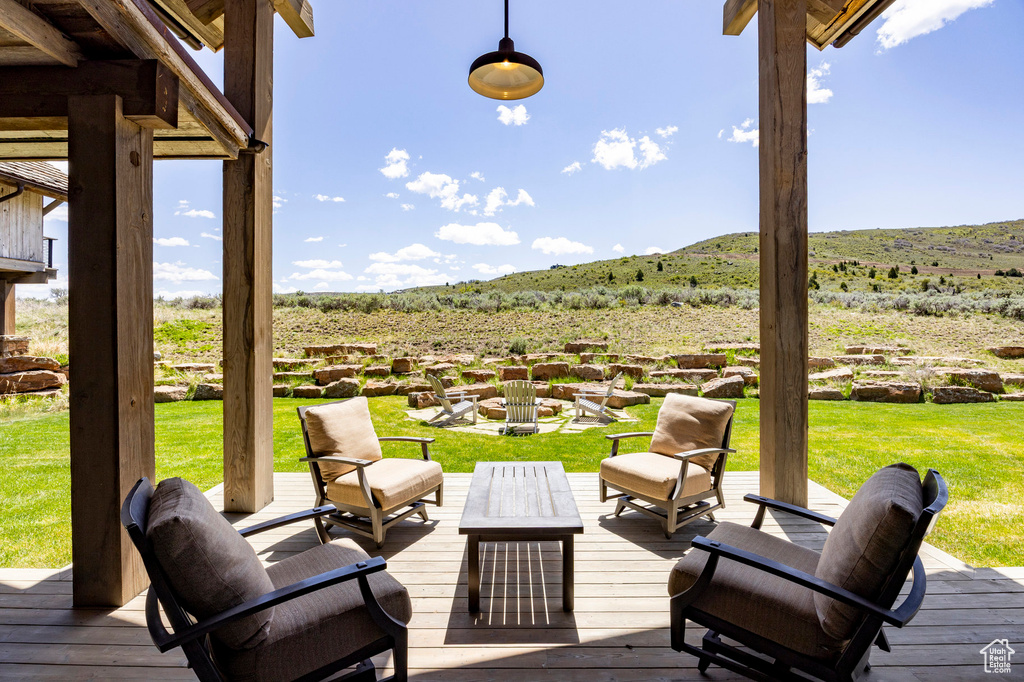 Wooden terrace with a mountain view and a yard