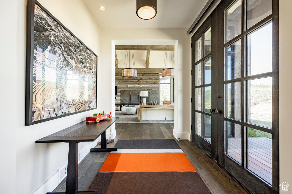 Hall featuring wood finished floors, french doors, and recessed lighting