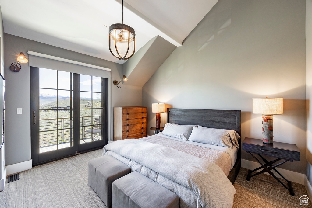 Carpeted bedroom featuring access to outside, lofted ceiling, baseboards, and a mountain view