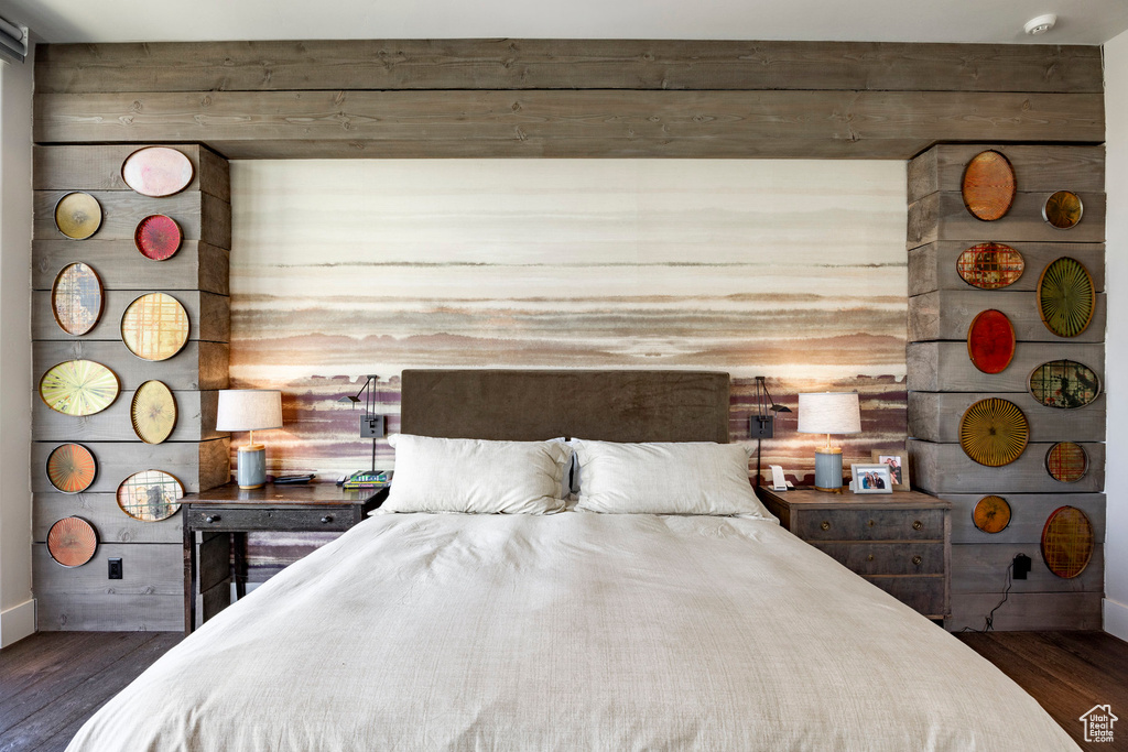 Bedroom with dark wood-type flooring and baseboards