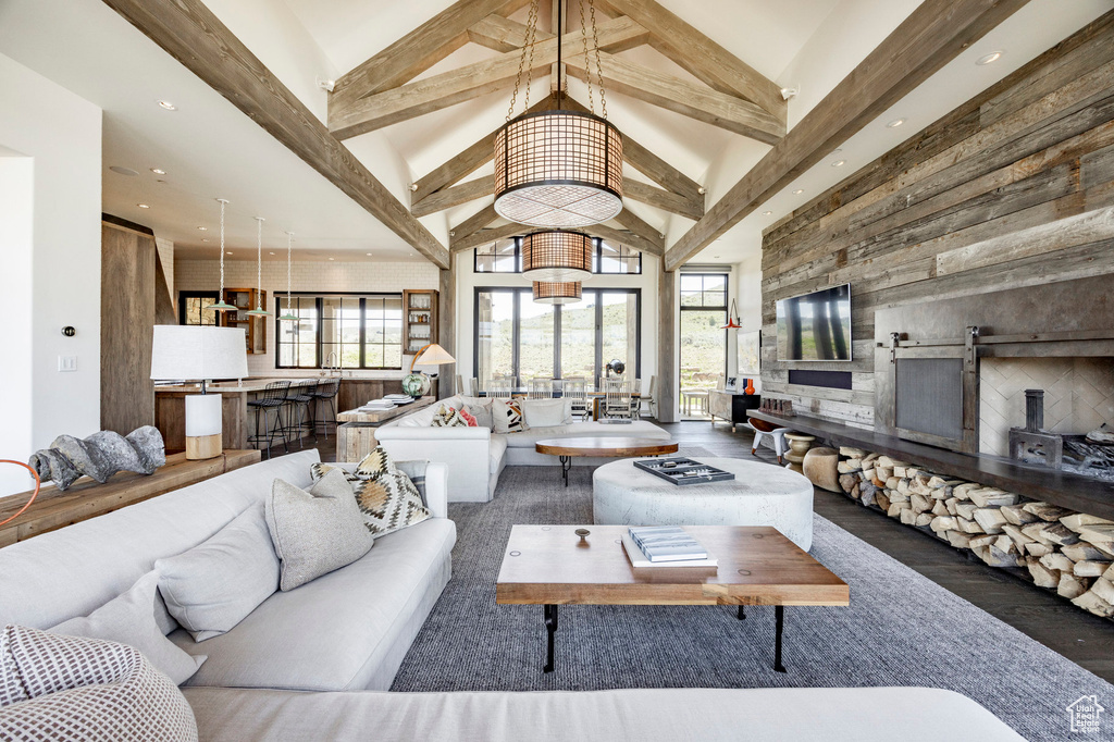 Living room featuring high vaulted ceiling, wood finished floors, beamed ceiling, and recessed lighting