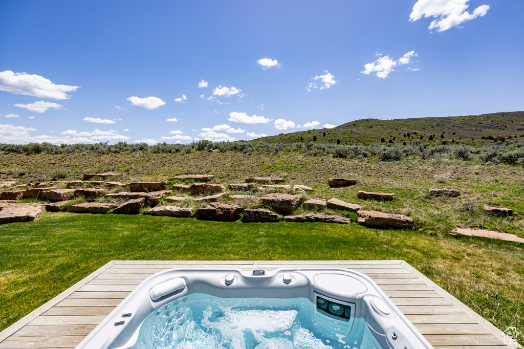 View of pool with a mountain view and a lawn
