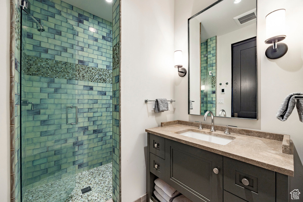 Bathroom with a shower stall and vanity