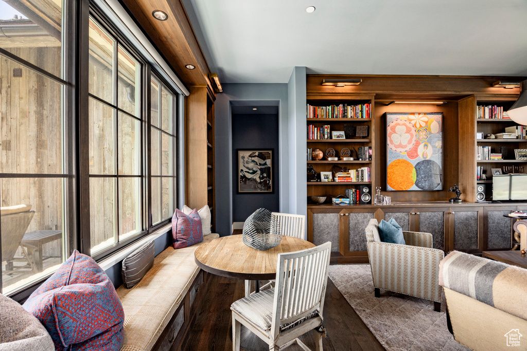 Dining space featuring wood finished floors, built in shelves, and recessed lighting