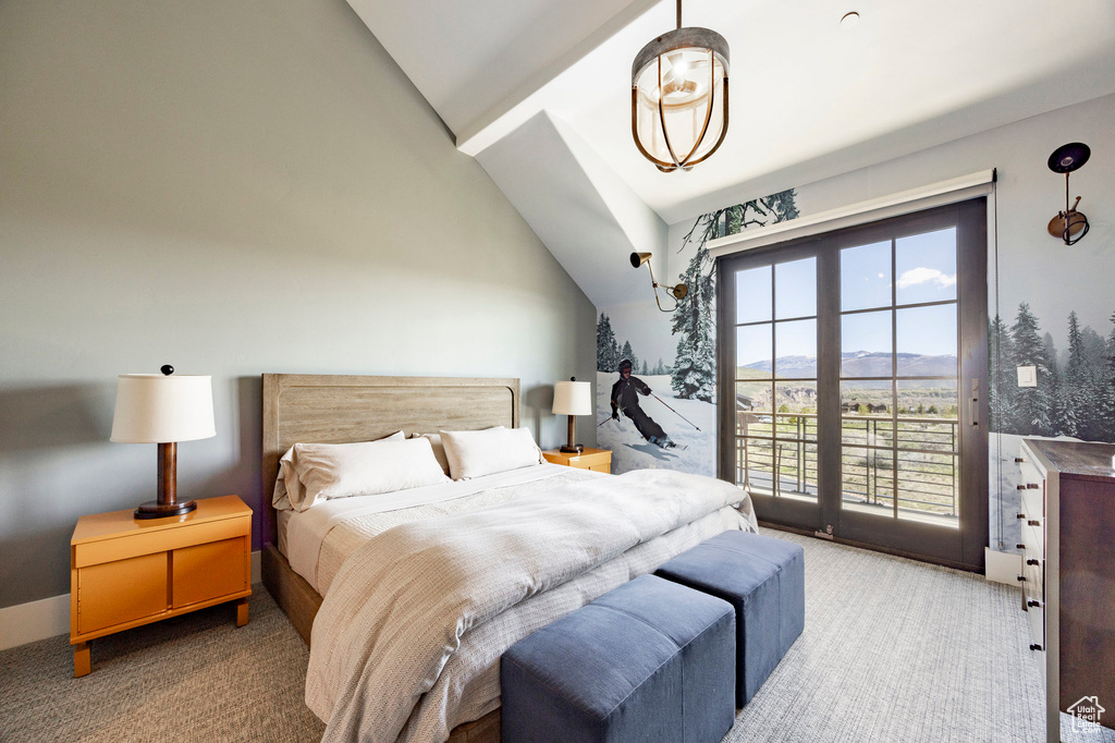 Bedroom featuring light carpet, vaulted ceiling, access to outside, and a mountain view