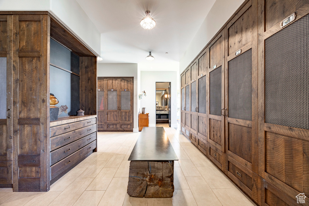 Hall featuring light tile patterned floors and baseboards