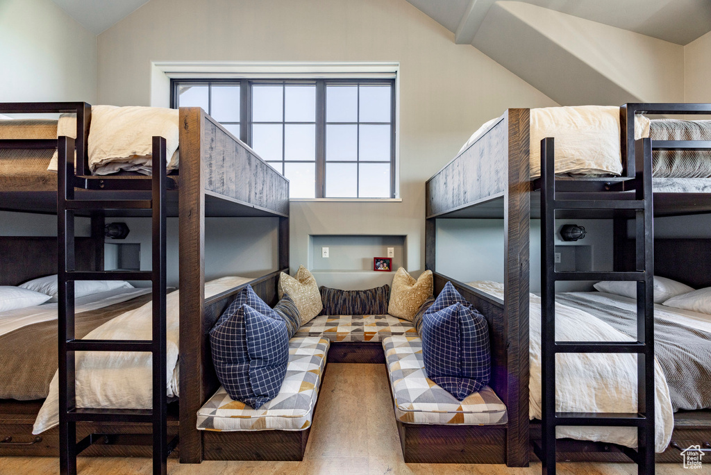 Bedroom featuring lofted ceiling and wood finished floors