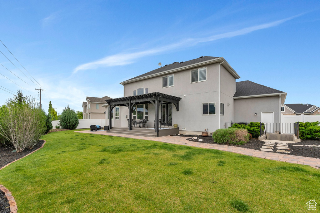 Back of house with a pergola, stucco siding, and a patio area