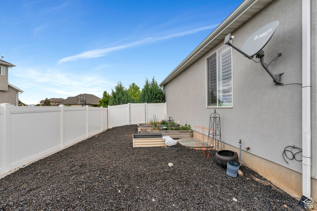 Fenced backyard with a vegetable garden