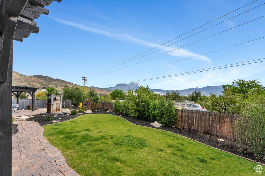 View of yard featuring a mountain view, a patio area, and a pergola