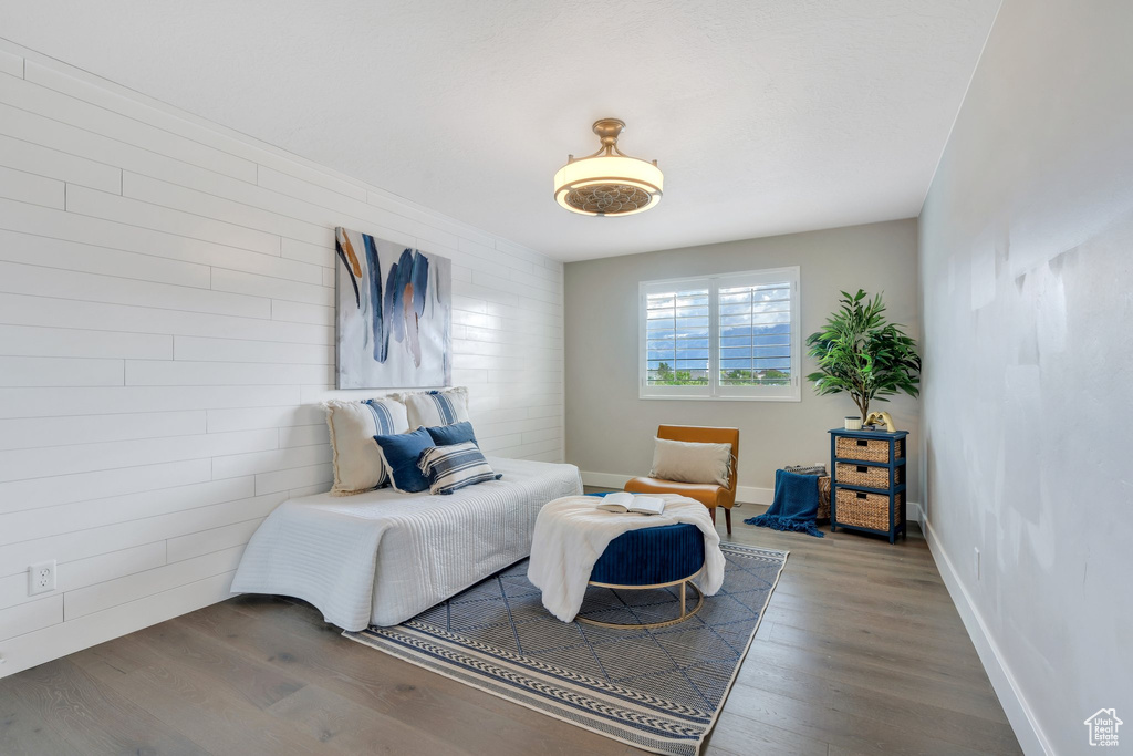 Bedroom with wood finished floors and baseboards