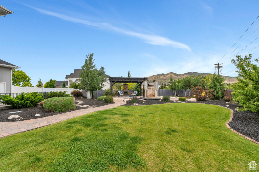 View of yard featuring a pergola, a patio area, and a mountain view