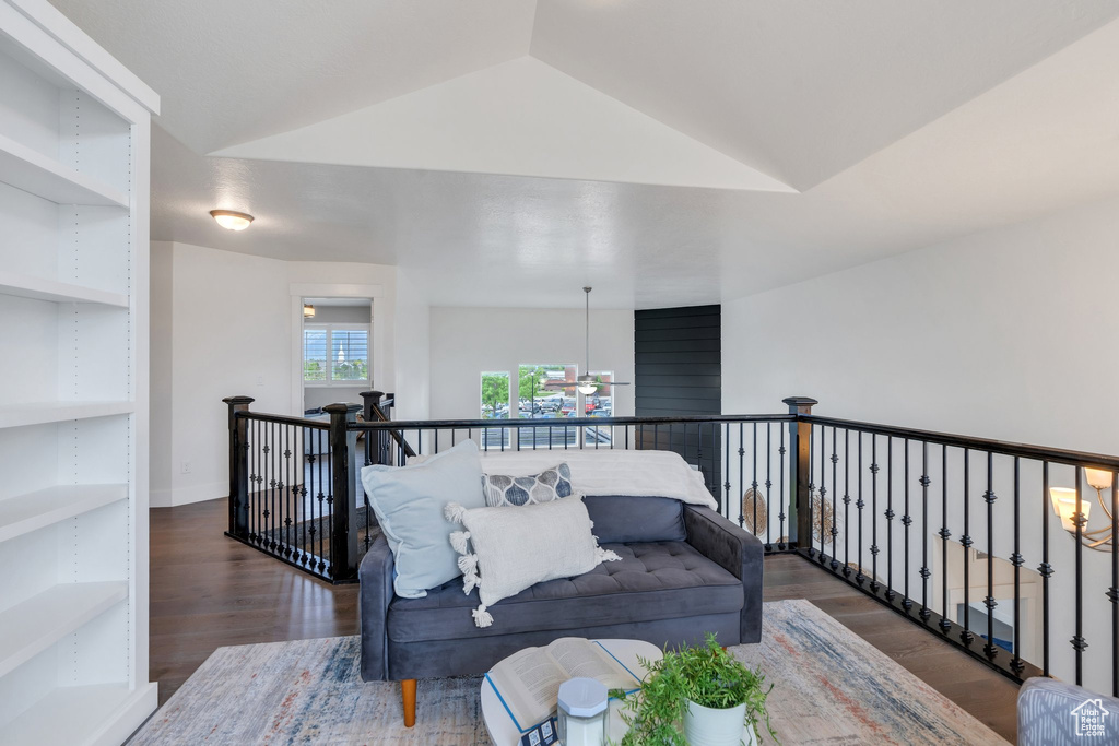 Living area with wood finished floors and lofted ceiling