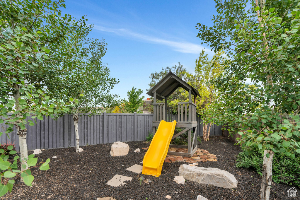 View of playground featuring a fenced backyard