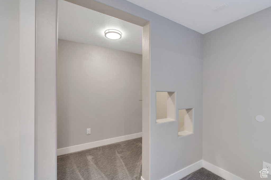 Spare room with baseboards and carpet flooring