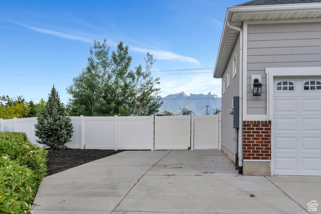 Garage featuring a gate, fence, and a mountain view