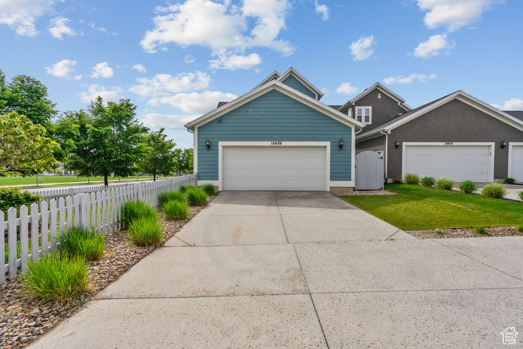 Traditional-style house with driveway and a garage