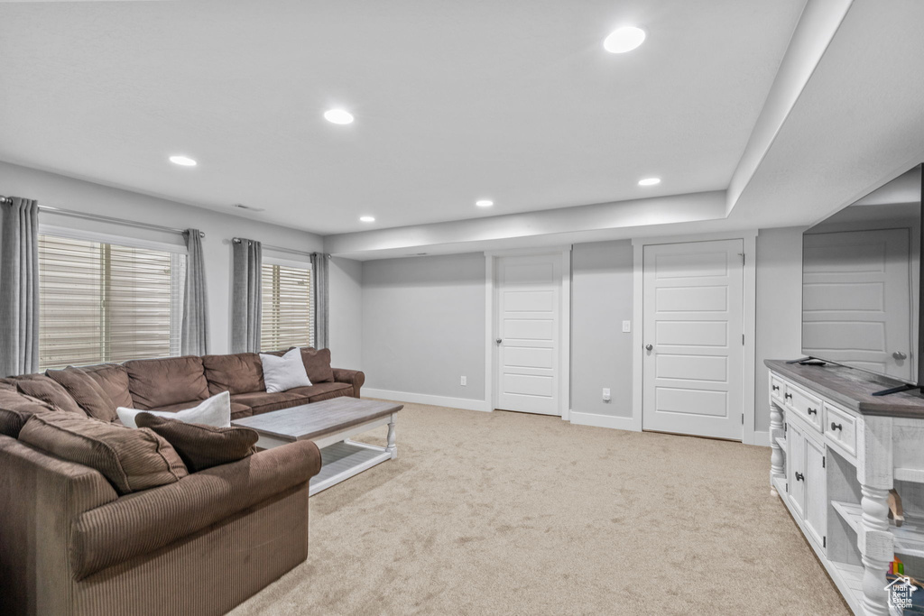 Living area featuring recessed lighting, light colored carpet, and baseboards