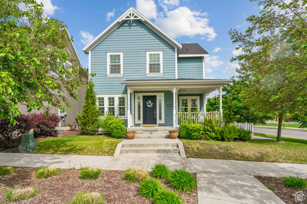 Traditional-style home with covered porch