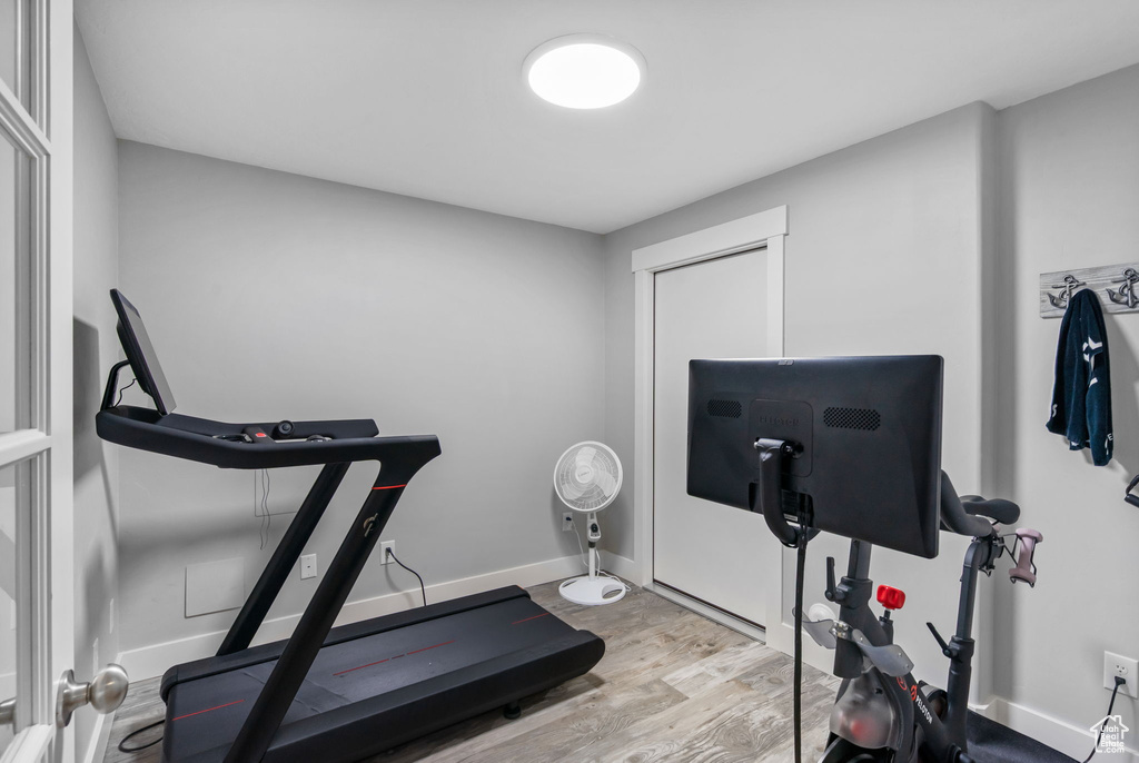 Exercise area featuring wood finished floors and baseboards