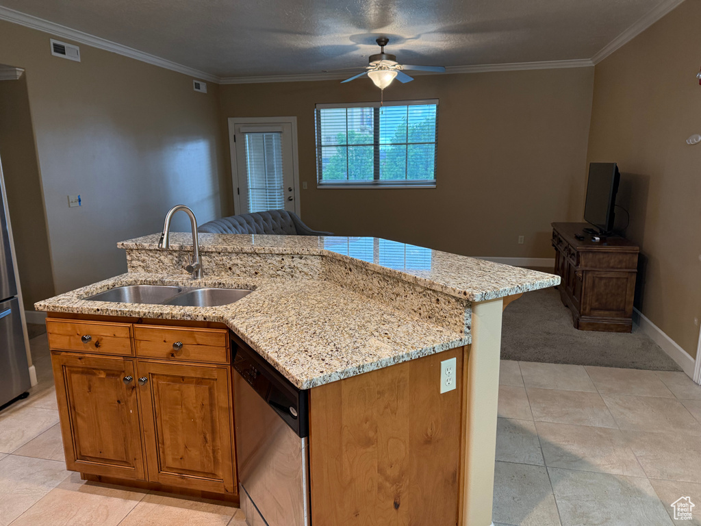 Kitchen with a sink, dishwasher, a ceiling fan, crown molding, and light stone counters